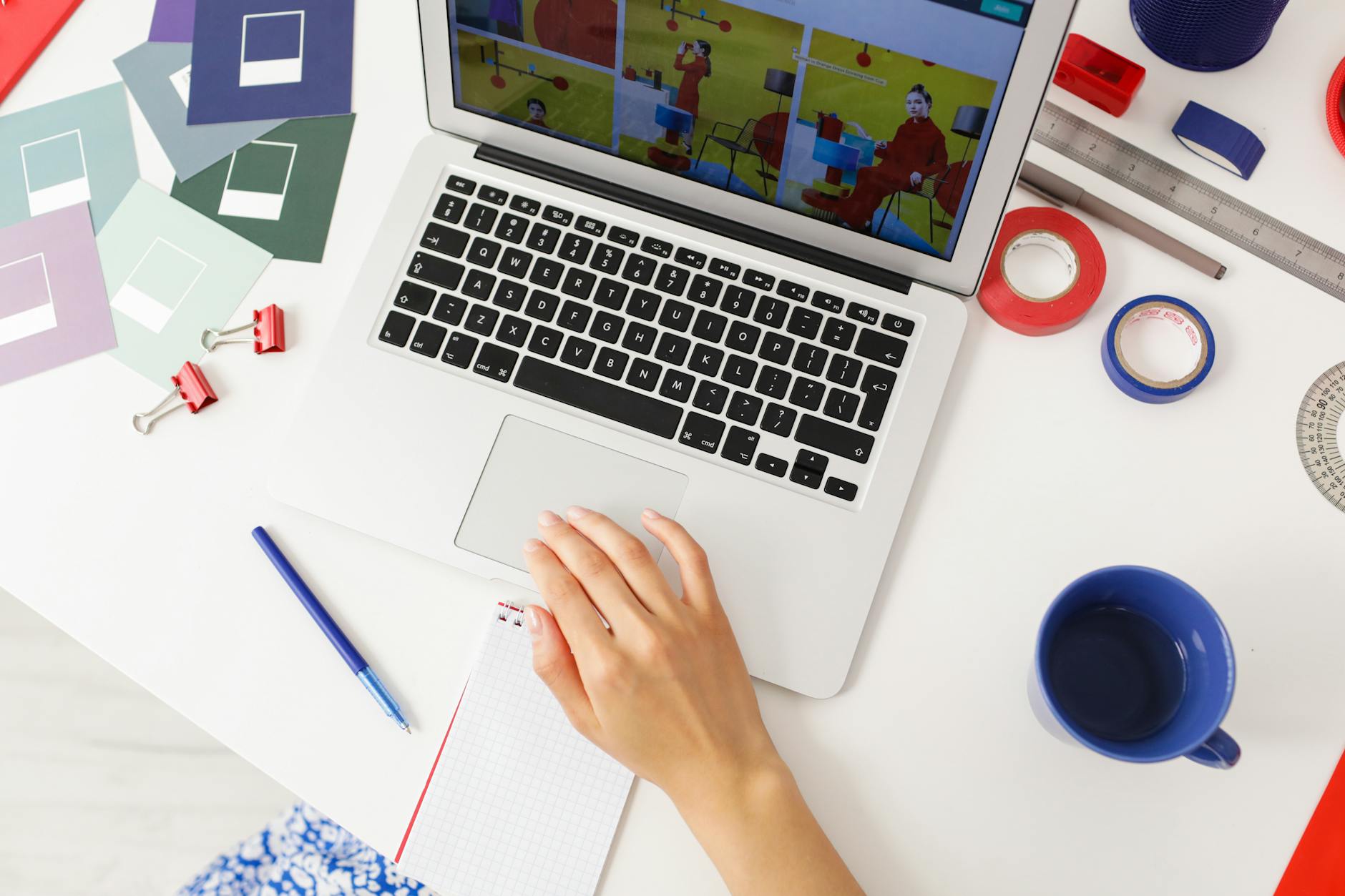 Designer on a laptop removing the background from a portrait photo in Canva, subject on a transparent checkerboard