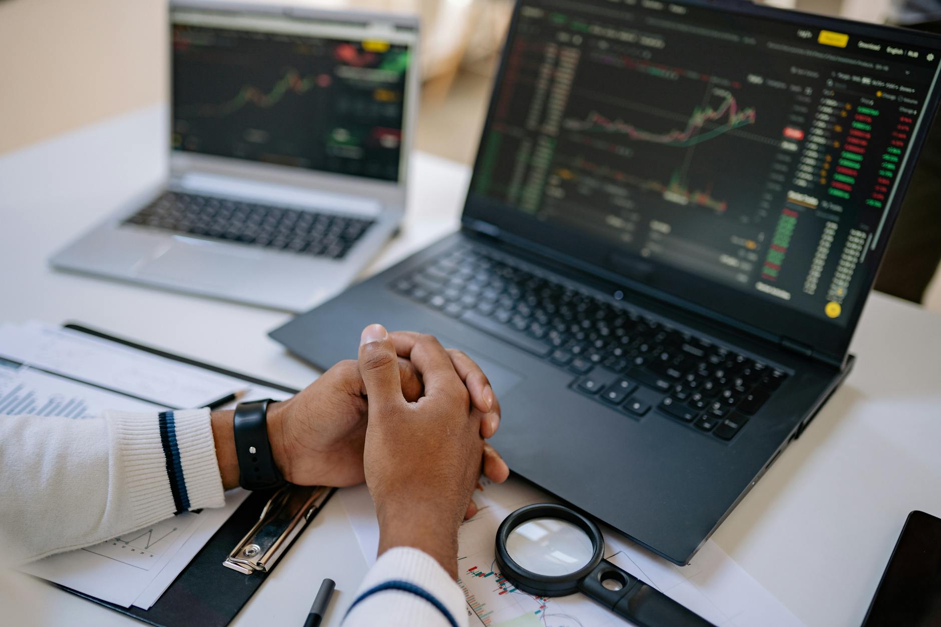Finance professional working on Excel spreadsheet at a laptop