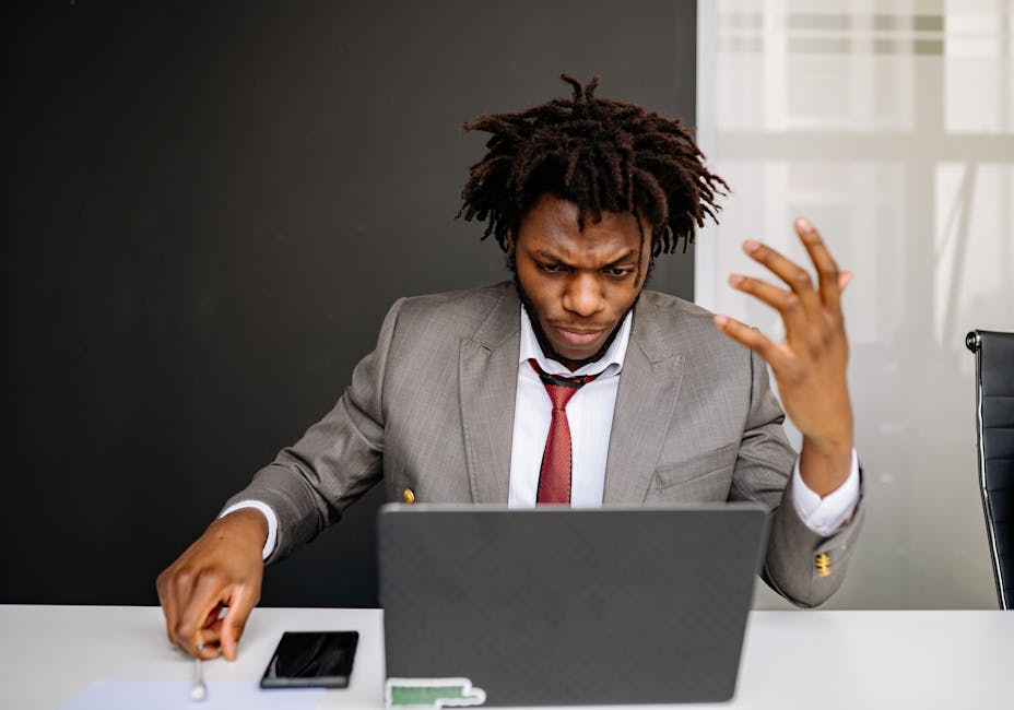 Office worker working through a problem on a laptop