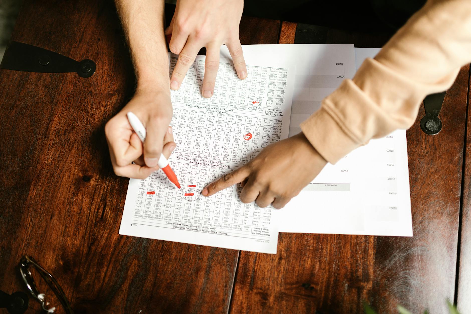 A person reviewing an Excel spreadsheet with troubleshooting notes