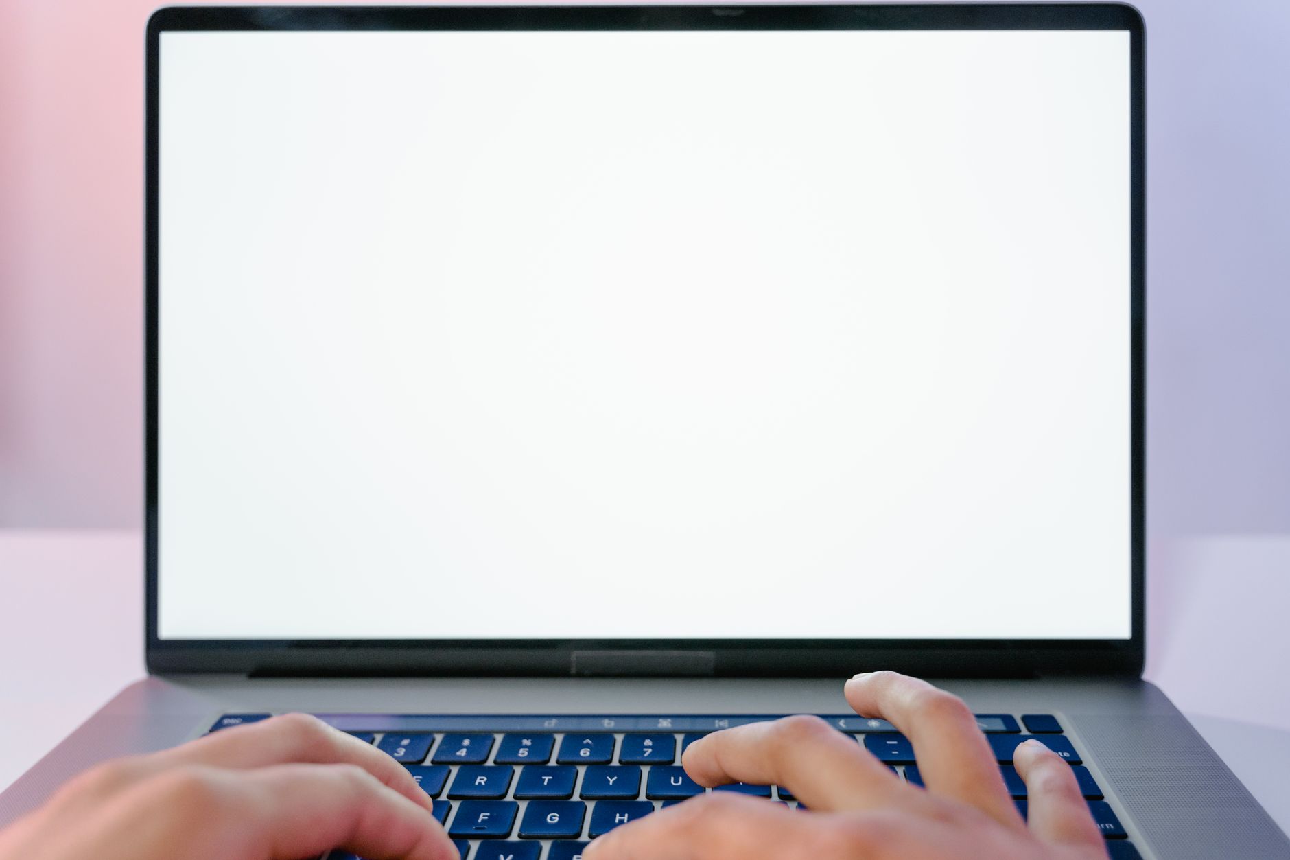 Typing a Copilot prompt to create a PowerPoint presentation on a laptop keyboard
