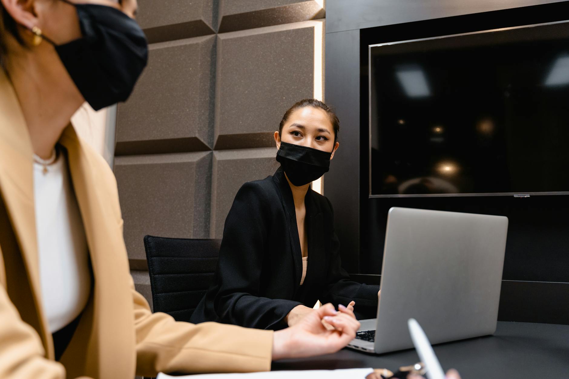 Two colleagues reviewing automation options on a laptop in a Singapore office