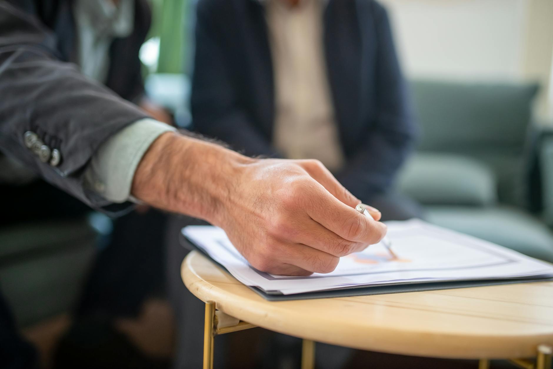 Two professionals reviewing a business proposal at a desk