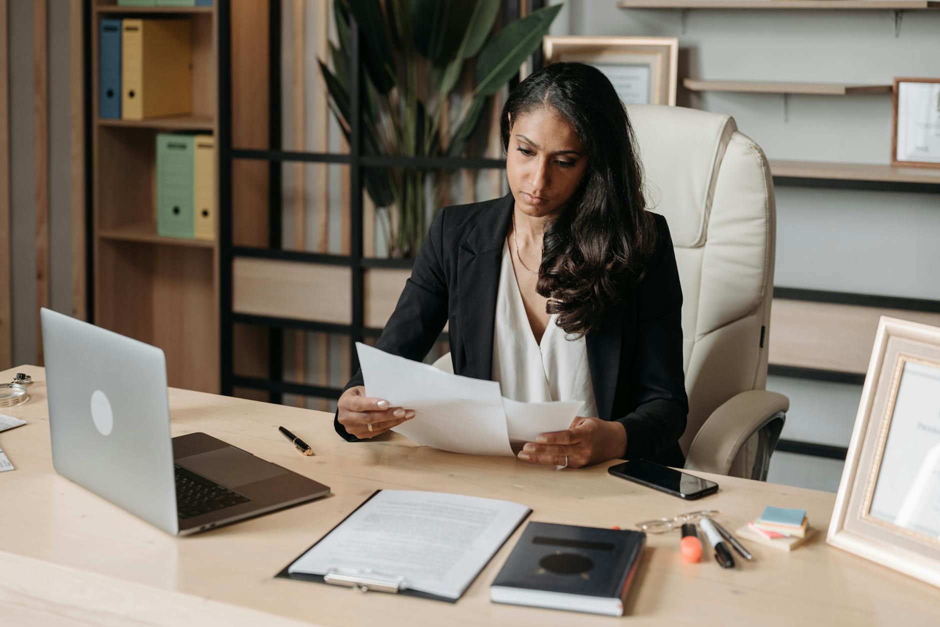 A professional reviewing Copilot meeting notes and action items on a laptop at a desk