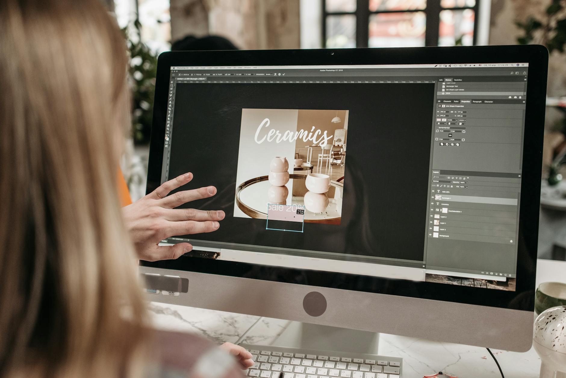 Arranging a Canva flyer layout on a desktop screen