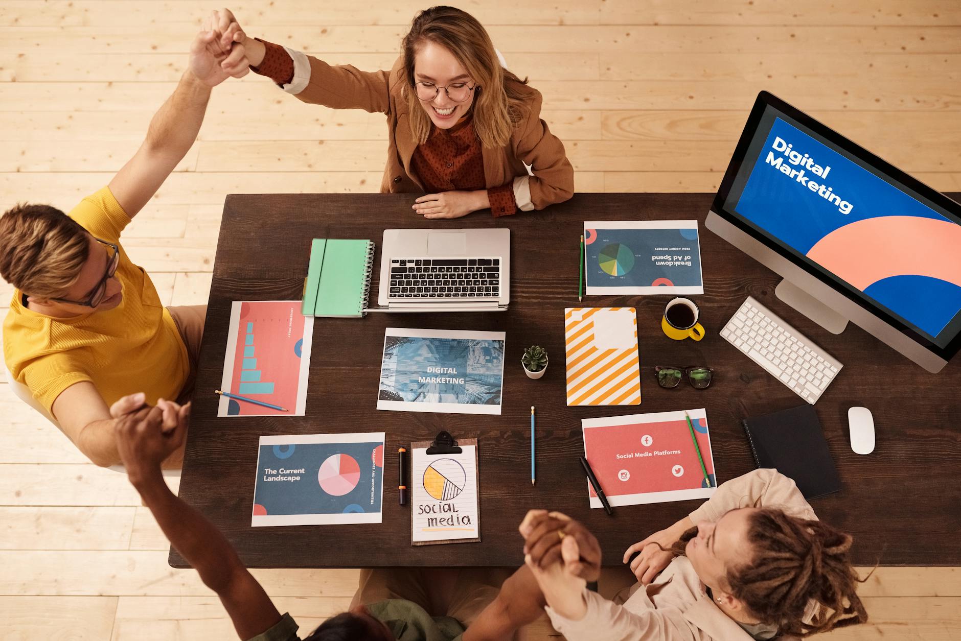 Team comparing background-removal results across Canva and remove.bg on screens in an office