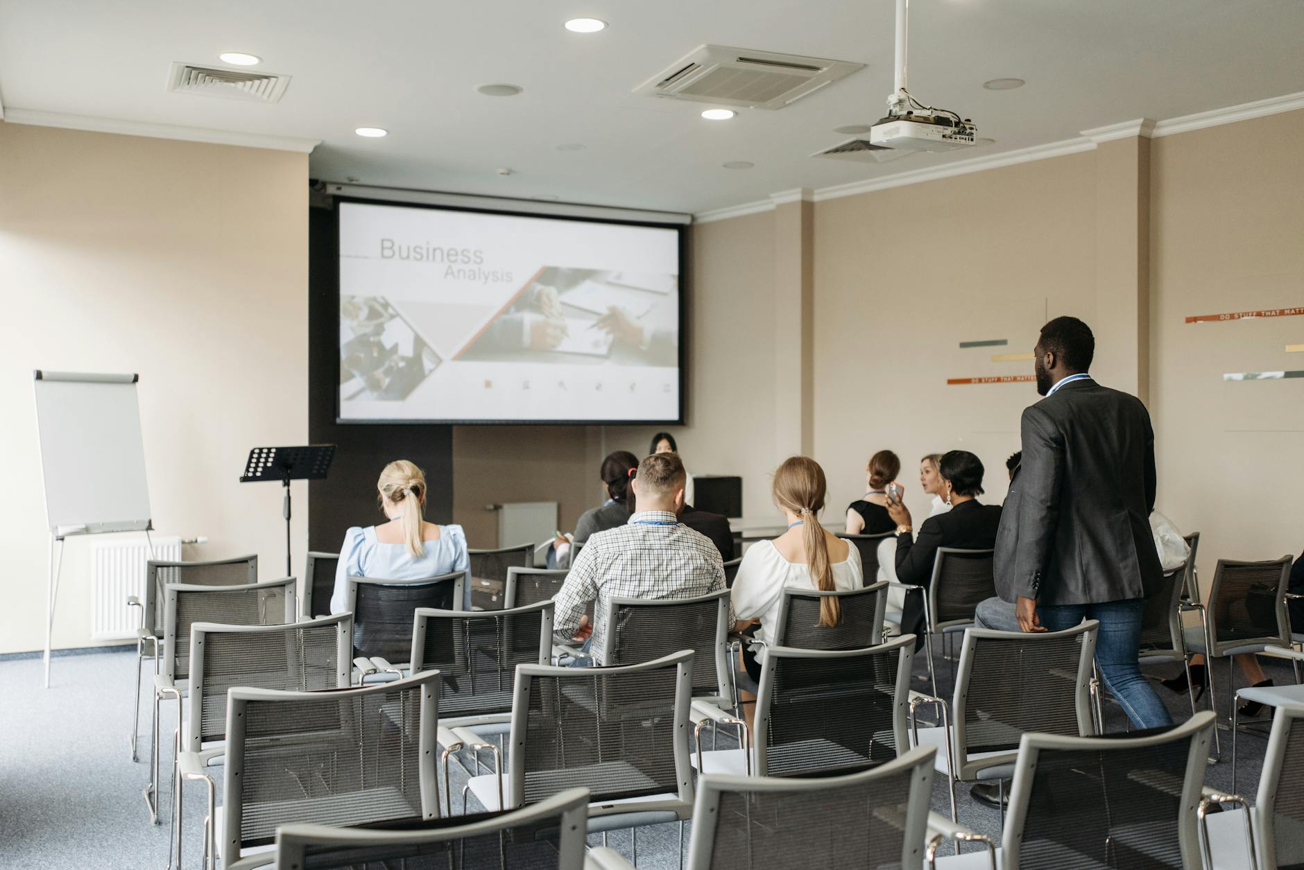Team reviewing and editing a Copilot-generated PowerPoint deck on a screen in a meeting room