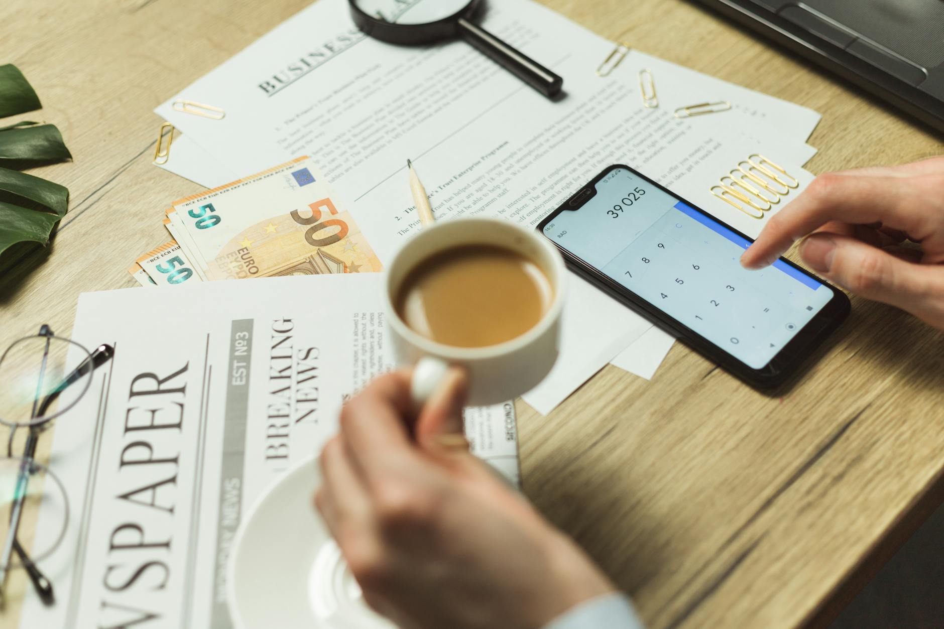 Phone screenshots and paper documents on a desk for JPG to PDF
