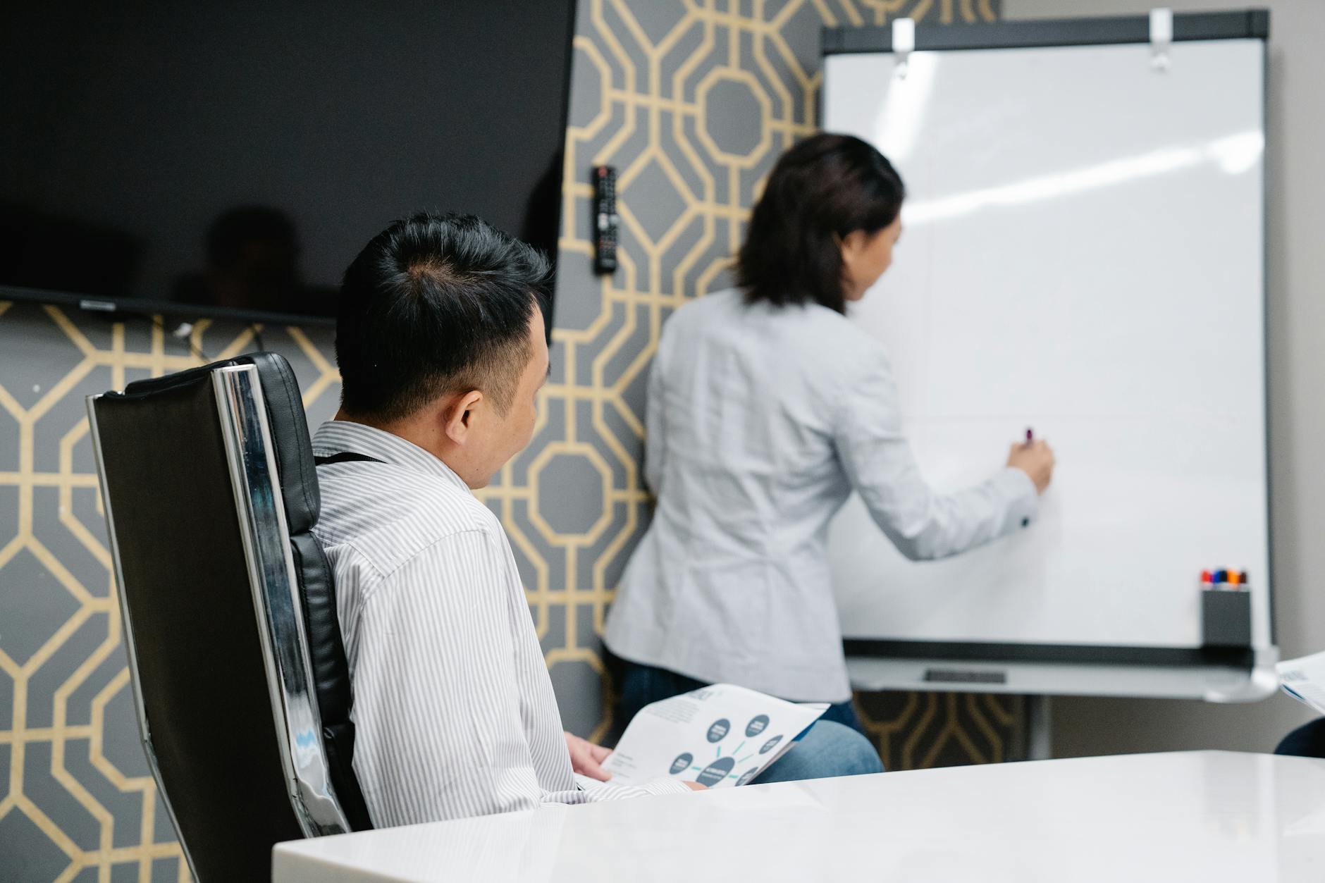 Professional business meeting reviewing a presentation in a Singapore office