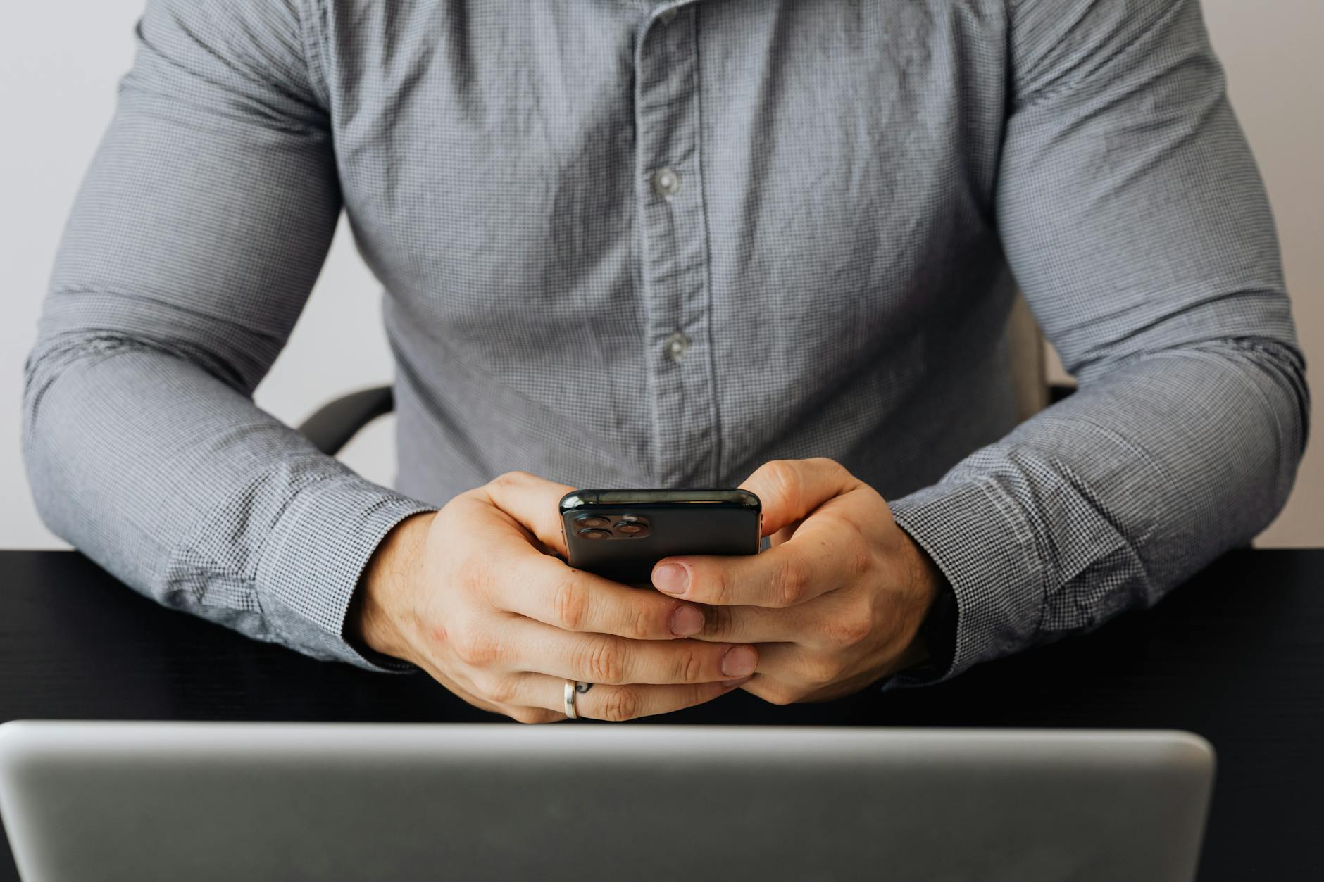 Person using a Teams chat on phone and laptop in a hybrid working setting