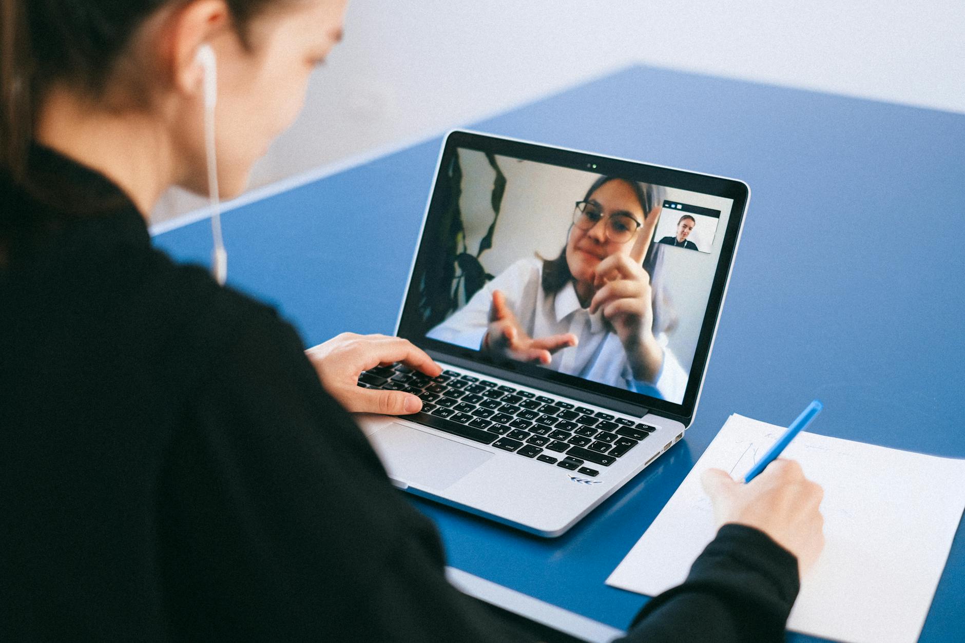A user taking notes while the Copilot panel is open during a video meeting