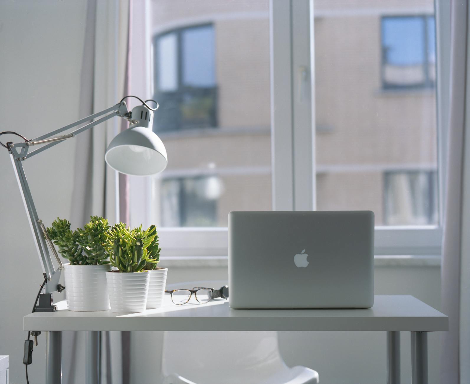 Copilot in PowerPoint running on a Mac laptop on a bright desk