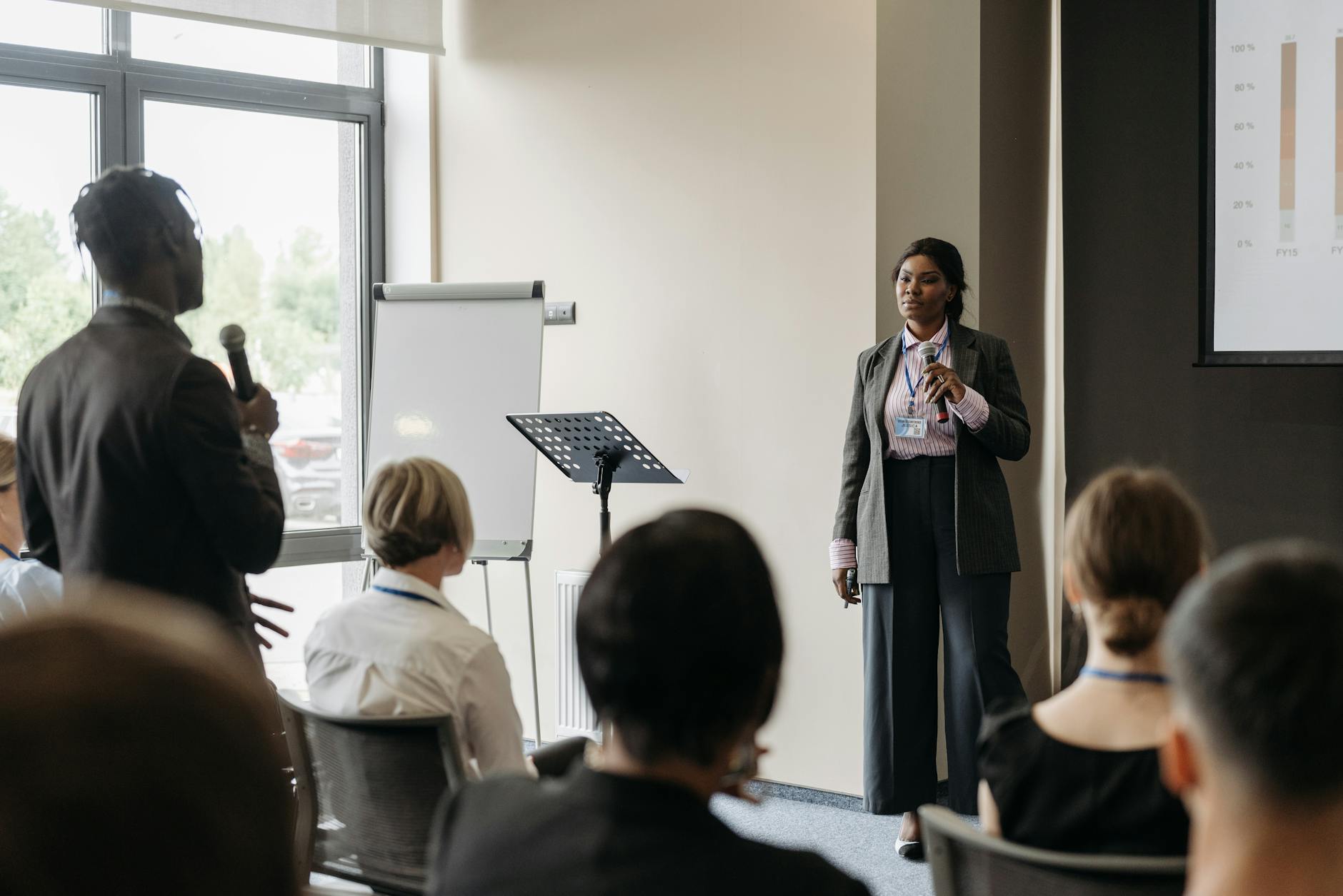 A presenter speaking to a small audience in a conference room