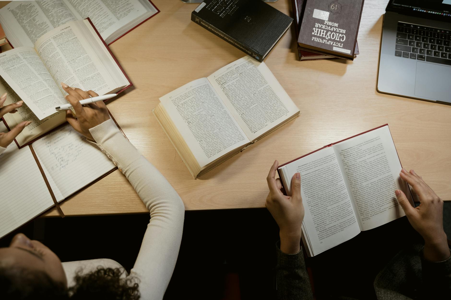 Open books and a laptop on a desk — a mixed Power BI learning library for beginners