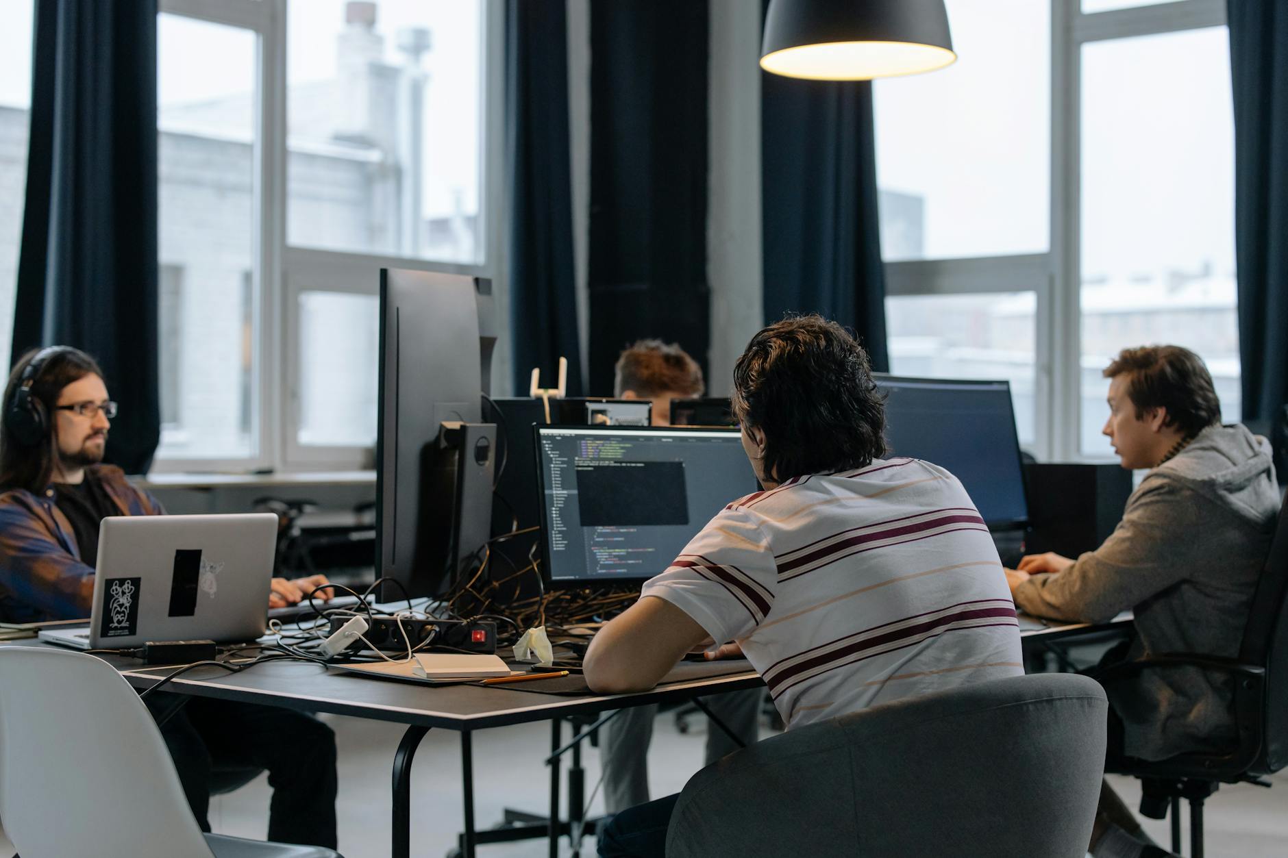 Office workers practising Microsoft 365 Copilot together at computers in a modern Singapore workplace